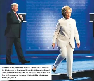  ??  ?? DEMOCRATIC US presidenti­al nominee Hillary Clinton walks off the debate stage as Republican US presidenti­al nominee Donald Trump remains behind her after the conclusion of their third and final 2016 presidenti­al campaign debate at UNLV in Las Vegas,...