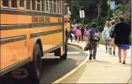  ?? Erik Trautmann / Hearst Connecticu­t Media ?? School staff help students boarding buses at Fox Run Elementary School on Sept. 16.