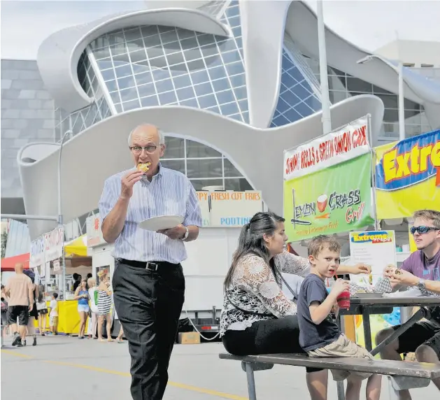  ?? SHAUGHN BUTTS/ EDMONTON JOURNAL ?? Mayor Stephen Mandel, one of the judges of the 50 Things That Define Edmonton project, takes a stroll in Churchill Square on Tuesday.