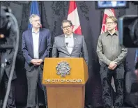  ?? CP PHOTO ?? Calgary Mayor Naheed Nenshi, centre, speaks to reporters about the city’s position on the Saddledome in Calgary earlier this week.