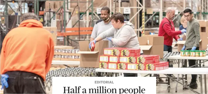  ?? TYLER LARIVIERE/SUN-TIMES FILES ?? Volunteers help repackage food at the Greater Chicago Food Depository on March 24, 2020.