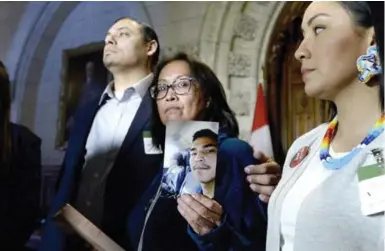  ?? JUSTIN TANG/THE CANADIAN PRESS ?? Debbie Baptiste holds a photo of her son, Colten Boushie. Prime Minister Justin Trudeau tweeted he “couldn’t imagine the grief and sorrow the Boushie family was feeling” after Saskatchew­an farmer Gerald Stanley was found not guilty of killing Boushie.