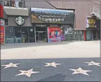  ?? (AP/Chris Pizzello) ?? A video marquee in the empty forecourt of Madame Tussauds Hollywood plays a “Stay Strong Hollywood!” message as stay-at-home orders continue in California due to the coronaviru­s on March 31, 2020, in Los Angeles.