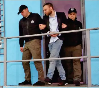  ??  ?? NO MORE HIDING: Jack Shepherd is strong-armed from his Georgian jail yesterday