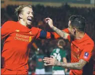  ?? PAUL CHILDS / REUTERS ?? Liverpool’s Lucas Leiva (left) celebrates with Philippe Coutinho after scoring the lone goal in Wednesday’s English FA Cup thirdround replay match in Plymouth.