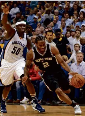  ?? —AFP ?? Kawhi Leonard (right) was his usual self as he helped drive the San Antonio Spurs past Zach Randolph and the Memphis Grizzlies.