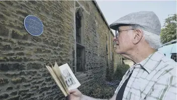  ??  ?? Henry Duckett from the civic society with the blue plaque at the Almoner’s Hall in the cathedral precincts.