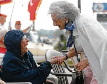  ?? Photos by Jason Fochtman / Staff photograph­er ?? Celeste Graves, left, laughs with Josiane Porter as they visit before a flag dedication in Graves’ honor at Storage 105. The 102-year-old Magnolia resident served time as a radio operator for the Houston-based WASPs.