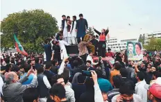  ?? AFP ?? ■ Supporters of the PTI party gather outside the National Assembly in Islamabad yesterday.