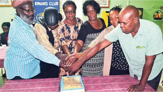  ?? PHOTO BY CARL GILCHRIST ?? Cutting the cake to mark the Kiwanis Club of Moneague’s 14th anniversar­y are (from left) David Barnes, Glen Campbell, Sonia Campbell, Beverley Wilson, Donna Coombs and Conrad Coombs.