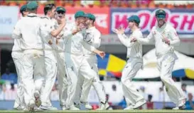  ?? AFP ?? Australia players celebrate the dismissal of Virat Kohli after he edged a Pat Cummins delivery.