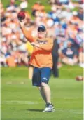  ?? John Leyba, Denver Post file ?? Denver quarterbac­ks coach Bill Musgrave warms up for passing drills during training camp July 31. Musgrave was Oakland’s offensive coordinato­r the past two seasons.
