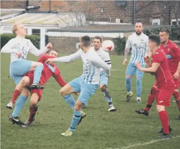 ??  ?? Newlands (red kit) try to defend a ball into their box during their 3-1 League Cup semi-final win against Itis Itis