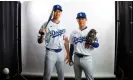  ?? Photograph: Mark J Rebilas/USA Today Sports ?? Los Angeles Dodgers designated hitter Shohei Ohtani, left, and pitcher Yoshinobu Yamamoto pose for a portrait during media day at Camelback Ranch. Both players’ jerseys can be seen tucked into their pants.