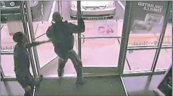  ??  ?? An image from a surveillan­ce video shows a portion of the alleged altercatio­n inside the T- Mobile store in Drexel Hill, according to police.