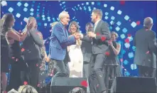  ?? John Katsilomet­es ?? Las Vegas Review-journal @Johnnykats Michael Buble mingles with Larry and Camille Ruvo on Saturday at the 22nd Keep Memory Alive Power of Love gala at MGM Grand Garden arena.