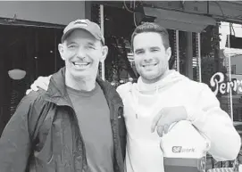  ?? COURTESY PHOTO ?? Nick Manis Jr., right, with his uncle Brian Adam, who has Parkinson’s Disease. Nick Manis, a former University of Maryland and Chesapeake Bayhawks lacrosse player, is running a marathon and swimming the Severn River to raise money to fight the disease.