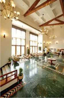  ??  ?? Clockwise from top: The lobby at Jaypee Residency Manor has polished wooden interiors and floor-to-ceiling windows; the life-size chess board at one of the court lawns; the plush Executive Room at the Residency Tower.