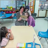  ?? LEE HOWARD/THE DAY ?? Melissa Root, a consultant who teaches video self modeling, works with students in Ali Curran’s special education class on March 27.