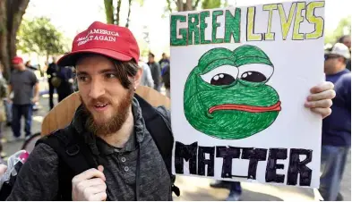  ??  ?? ABOVE: A right wing protester holds a sign of Pepe the Frog at a rally in Berkeley, California, on 27 April 2017. BELOW: The yellow-on-black ‘chaos star’ used by as an emblem by Alexandr Dugin’s youth movement.