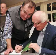  ??  ?? Dr Declan Downey congratula­tes Pat Neligan on the launch of his book ‘The Knave of Trumps’ in Benner’s Hotel on Sunday and (right) Pat signs a copy for past pupil John Benny Moriarty.