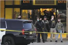  ?? Nam Y. Huh / Associated Press ?? FBI officials and police gather at Mayfair Mall after a shooting that injured seven adults and a teenager in Wauwatosa, Wis.