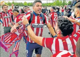  ?? AP ?? Atletico Madrid's Luis Suarez celebrates with fans after winning the La Liga title.