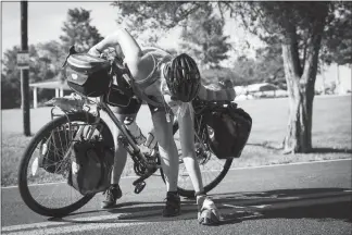  ?? PHOTOS BY MAX WHITTAKER / THE NEW YORK TIMES ?? Sara Lee stops to move a turtle from the road in St. Mary, Mo., on July 12 during the 4,200-mile ride across America she was making with a fellow veteran. “It reminds me what I’m capable of,” Lee said. “And I’m trying to honor the friends I lost by living a full life.”