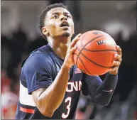  ?? John Minchillo / Associated Press ?? UConn’s Alterique Gilbert takes a foul shot during overtime against Cincinnati on Saturday.