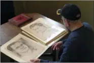  ?? CHRIS CAROLA — THE ASSOCIATED PRESS ?? World War II veteran Wilfred “Spike” Mailloux looks through a series of sketches of U.S. Army 27th Infantry Division soldiers while visiting the New York State Military Museum and Veterans Research Center in Saratoga Springs, N.Y.