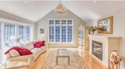  ?? TYLER MCKEAG ?? The sunken great room has a cathedral ceiling, hardwood flooring, crystal chandelier, gas fireplace a large window and a double garden door walkout.