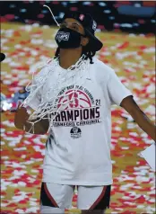  ?? PHOTO BY ETHAN MILLER — GETTY IMAGES ?? Stanford’s Kiana Williams wears a net around her neck after it was cut down by her head coach Tara VanDerveer following the team’s 75-55 victory over UCLA to win the Pac-12 championsh­ip game on March 7 in Las Vegas.