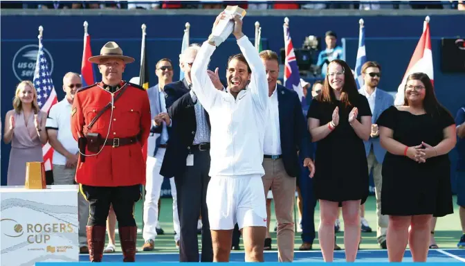  ?? — AFP ?? TORONTO: Rafael Nadal of Spain with the champions trophy following his win in the final match against Stefanos Tsitsipas of Greece on Day 7 of the Rogers Cup at Aviva Centre on Sunday in Toronto, Canada.