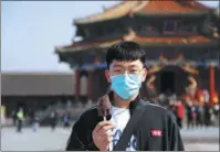  ?? YU HAIYANG/CHINA NEWS SERVICE ?? A tourist holds an ice cream from Shenyang Palace Museum during the Labor Day holiday in May 2021.