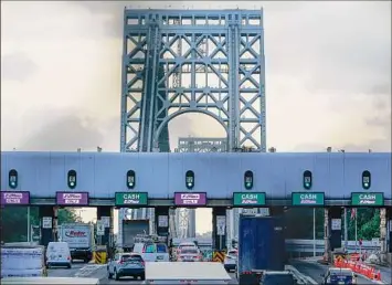  ?? Seth Wenig / Associated Press ?? Cars pass through toll booths for the George Washington Bridge in Fort Lee, N.J. The busy bridge connecting New Jersey and New York City is moving to cashless tolls Sunday.