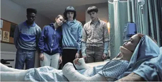  ?? NETFLIX VIA AP ?? From left, Caleb Mclaughlin as Lucas Sinclair, Millie Bobby Brown as Eleven, Finn Wolfhard as Mike Wheeler, Noah Schnapp as Will Byers, and Sadie Sink as Max Mayfield, foreground, in a scene from “Stranger Things.”