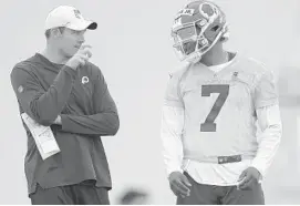  ?? JOHN MCDONNELL/THE WASHINGTON POST ?? Assistant coach Kevin O’Connell, left, speaks with quarterbac­k Dwayne Haskins during Washington’s rookie camp in May.