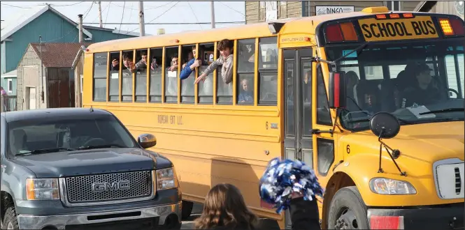  ?? Photo by Peter Loewi ?? CHAMPIONS—The Nome-Beltz Boys Basketball team waves to the crowd as they pass through town upon the return to Nome on Sunday.