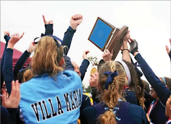  ?? BILL RUDICK — DIGITAL FIRST MEDIA ?? Villa Maria players celebrate around the trophy after winning the PIAA Class 2A field hockey championsh­ip with a 2-1victory over Wyoming Valley West at Zephyr Sports Complex at Whitehall-Coplay High School on Saturday.