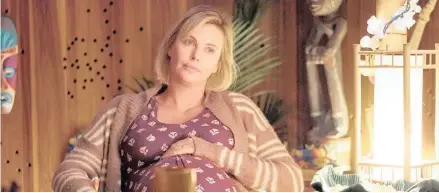  ??  ?? NEVER BETTER: Charlize Theron plays a pregnant mom in a scene from Tully.