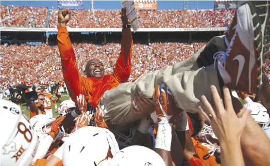  ?? | ANDY JACOBSOHN/AP ?? Coach Charlie Strong is the picture of elation as he is hoisted by his players after Texas’ upset Saturday of No. 10 Oklahoma in the Red River Rivalry in Dallas.