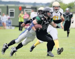  ?? Tim Furfie ?? Halton Spartans defensive back Conor Tyrer looks to advance with the ball against the Leeds Bobcats.