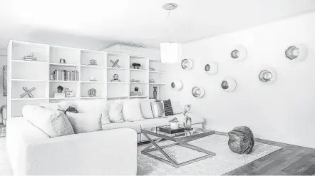  ?? Courtesy photo ?? Brass and white accents in a white room create interest, as in this living space that also features white sofas and chairs.