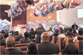  ?? MICHAEL SEARS / MILWAUKEE JOURNAL SENTINEL ?? Pastor Carol Polk, center, delivers the eulogy at the funeral of sisters A’Lisa “Lisa” Z. Gee, 6, and Amea N. Gee, 4 who were struck and killed by a hit-and-run driver while crossing the street. The funeral was at Jerusalem Missionary Baptist Church in Milwaukee.