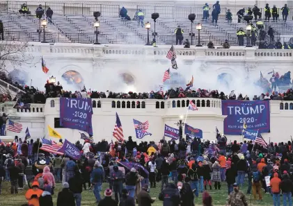  ?? JOHN MINCHILLO/AP ?? Supporters of Donald Trump storm the U.S. Capitol on Jan. 6, 2021.