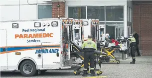  ?? NATHAN DENETTE THE CANADIAN PRESS ?? Paramedics transport a man to a Mississaug­a hospital this week. “Long-term-care deaths didn’t move this province, but hospital capacity belatedly did,” Bruce Arthur writes.