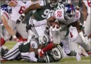  ?? JULIO CORTEZ — THE ASSOCIATED PRESS ?? New York Giants running back Wayne Gallman (22) is tackled by the New York Jets during the third quarter of a preseason NFL football game Friday in East Rutherford, N.J.