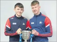  ?? ?? Patrick O’Grady and Niall Murray with the Munster minor football trophy, at the receipt of their medals on November 28th.