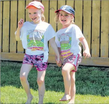  ?? KATHERINE HUNT/THE GUARDIAN ?? Piper Bjorklund, 6, and her cousin Emerson MacPhee, 4, got their feet moving at the 2018 Rollo Bay Fiddle Festival held on the weekend.