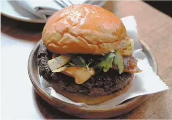  ??  ?? BEEFED-UP: Hip Harvard Square eatery Alden & Harlow is hosting its own ‘Burger Marathon’ tomorrow as it airs Boston Marathon coverage.